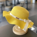 Yellow girls' straw sun hat featuring a white ribbon bow and leather bear tag - Yellow (Hat)