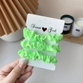 Three-pack of neon green satin scrunchies on a Sweet Girl card for women's hair styling - 3 Piece Set / Fluorescent Green