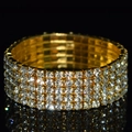 Detailed macro view of four-row sparkling crystals on a golden stretch bridal bracelet - 5 Row Gold Clear Rhinestone Bracelet