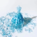 Close-up of blue crystal resin dress ornament with matching gravel stones on white background - Sky Blue