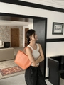 Detailed view of the bright orange woven tote bag showing large capacity and texture - Small / Orange