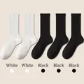 Five-pack of cotton mid-calf sports socks in white and black with ribbed elastic cuffs - One Size