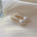 Elegant freshwater pearl drop earrings with gold hooks on silk background - Gold