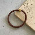 Dettaglio di un elastico per capelli intrecciato marrone con chiusura in metallo oro - Caffè chiaro