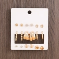 9 pairs of gold fashion earrings set featuring studs and hoops on a display card - Rhinestone Star Heart Twisted U-Shape 9 Pairs Earring Set