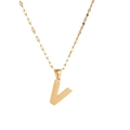 Macro view of gold stainless steel necklace with textured letter V pendant detail - Letter V