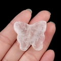 Handheld view of a carved pink quartz butterfly ornament with semi-transparent texture - White Crystal / 30*35mm No Hole
