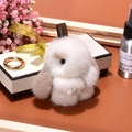 Cute white mink fur rabbit keychain with beige ears shown with elegant gift props - 8cm / White and Khaki