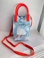 Knitted crossbody phone bag in light blue with white cloud pattern and orange handles - Playing Duck