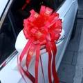 Red wedding bow decoration with gold Xi characters tied to a car side mirror - Bright Red with Square Xi Character