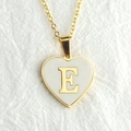 Golden heart-shaped shell necklace featuring a delicate uppercase letter E pendant - Letter E / Gold