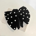 Detailed view of black velvet bow hair claw clip with white pearls on a stone surface - Velvet Pearl Bow / Black