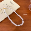 French vintage necklace with 10mm white pearls and golden clasp on a retro book - 10mm Pearl