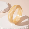 Detail of faceted amber acrylic bangle showing marbled texture on textured stone base - Beige Faceted Bangle (86#)