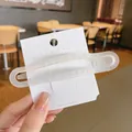 Minimalist matte translucent white hollow hair clip on a premium display card - Clear White
