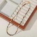Colorful beaded necklace with African turquoise and freshwater pearls on display - New Pop Color Beading
