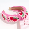 Detail of pink knitted headband featuring embroidered red cherries and green leaves - Cherry Knotted