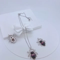 Detailed view of spider pendant set with black and pink zircons on display stand - #6 Silver Spider Set with Black & Pink Stones A