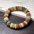 Multi-color carved Bodhi root bracelet with cat paw charms on Chinese calligraphy background - Nine-Petal Lotus