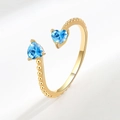 Gold open ring featuring twin blue heart-shaped zircons and delicate beaded texture - March (Light Blue)