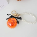 Preserved orange rose keychain with pearl strap and gold hardware in clear sphere - Orange