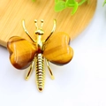 Detailed close-up of tiger eye stone butterfly wings set in golden alloy frame - Gold Plated Tiger Eye