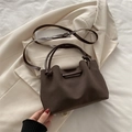 Retro dark brown crossbody bag with knot handle and suede finish in 45-degree view - Brown