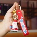 3D Weihnachtsmann Schlüsselanhänger mit rotem HAPPY Silikonband und Goldglöckchen - Weihnachtsmann A
