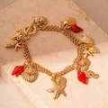Golden multi-strand starfish bracelet with three vibrant red enamel shell charms - Red Starfish Conch Seahorse Triple Layer Necklace