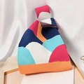 Knit knot bag featuring bold geometric color blocks in blue, red, and orange tones - Irregular Color-blocked Orange Base