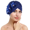 Detail of navy blue pleated headwrap with three silk flowers and pearl accents - Royal Blue
