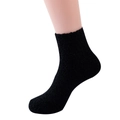 Cozy black fuzzy slipper socks for women in soft coral fleece on a white background - Black