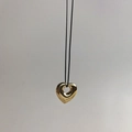 Close-up of golden hollow heart pendant on a minimalist black cord necklace - Gold Hollow Heart (Cord)
