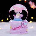 Pink musical snow globe with cartoon girl and cat, featuring LUCKY base inscription - 2426 Pink Base / Large Size 100+ Spins + Snow + Colored Lights + Music