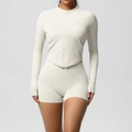 Detail view of cream white yoga set with high-waist shorts and thumbhole zip-up top - Light Ivory