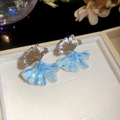 Detailed shot of elegant ginkgo leaf earrings with blue marbled enamel and silver finish - 75# Silver Ginkgo Leaf Blue White Gradient Studs