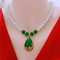 Detail of white pearl necklace with large green teardrop pendant and golden accents - Imitation Pearl Necklace - Green