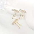 Macro detail of gold plated ribbon bow pendant featuring micro-set zircon accents - Three Zirconia Bow (PJ0310) / Gold