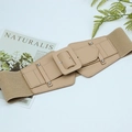 Detail of beige elastic wide waist belt featuring a rectangular buckle and silver studs - Khaki