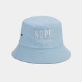Detail of light blue cotton bucket hat with white 'NOPE' letter embroidery and metal eyelets - One Size / Light Blue
