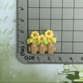 Flat back resin floral fence cabochon for DIY crafts measured on a scale mat - Yellow Flower Fence