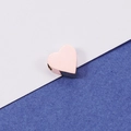 Macro shot of a rose gold heart-shaped stainless steel bead for DIY jewelry making - Rose Gold