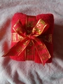Red coral fleece gift towel folded into square with gold-edged Xi character ribbon - Wedding Double Happiness Bow Towel