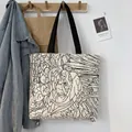 Artistic angel illustration detail on white canvas tote bag with black strap - Angel Double-sided Print