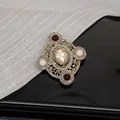 Macro detail of Baroque vintage brooch featuring micro-pave diamonds and oval crystal - Style B Retro Coffee Gold