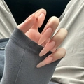 Glossy nude pink long almond press-on nails with a natural transparent finish on hands - Stiletto Nude (BY1463) / Phototherapy Glue Style