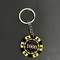 Macro view of a yellow and black poker chip keychain with crown and suit symbols - Yellow Black Chip 1000 Keychain (PY007-1000)
