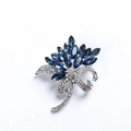 Detailed view of flower brooch featuring blue crystals and shimmering rhinestones - Blue Flower