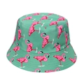 Detailed view of pink flamingo patterns on green canvas reversible bucket hat - Green