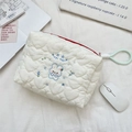 Close-up of quilted heart pattern on white makeup bag with cute rabbit embroidery detail - Happy Rabbit